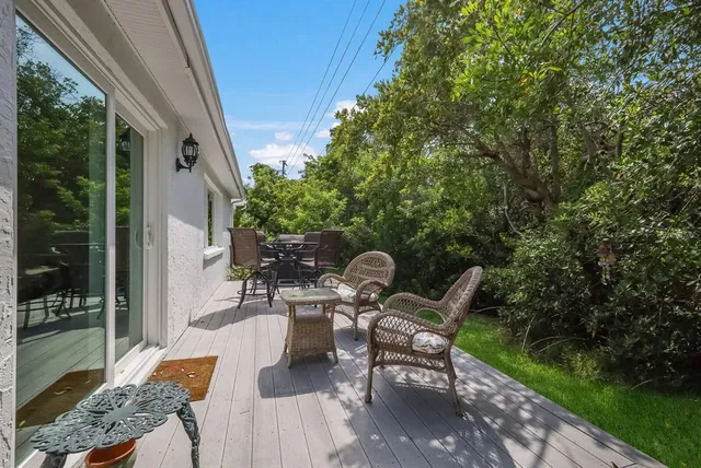 a view of a house with backyard sitting area and garden