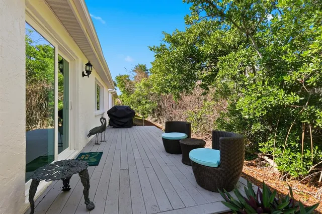a view of a deck with couches and wooden floor