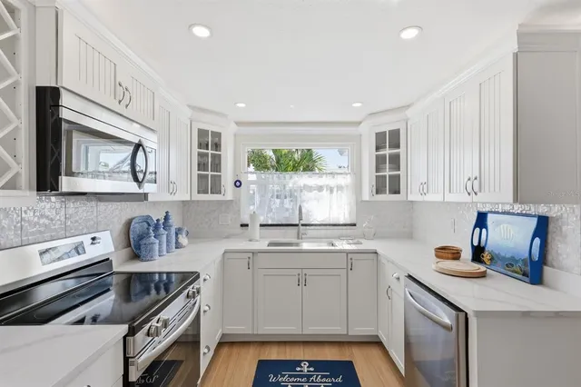 a kitchen with a sink stove and microwave