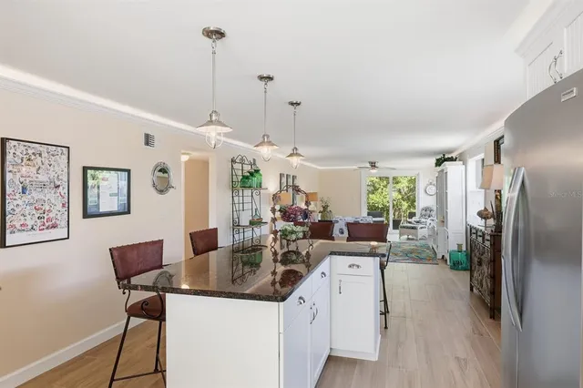 a kitchen with stainless steel appliances granite countertop a sink a stove and a refrigerator