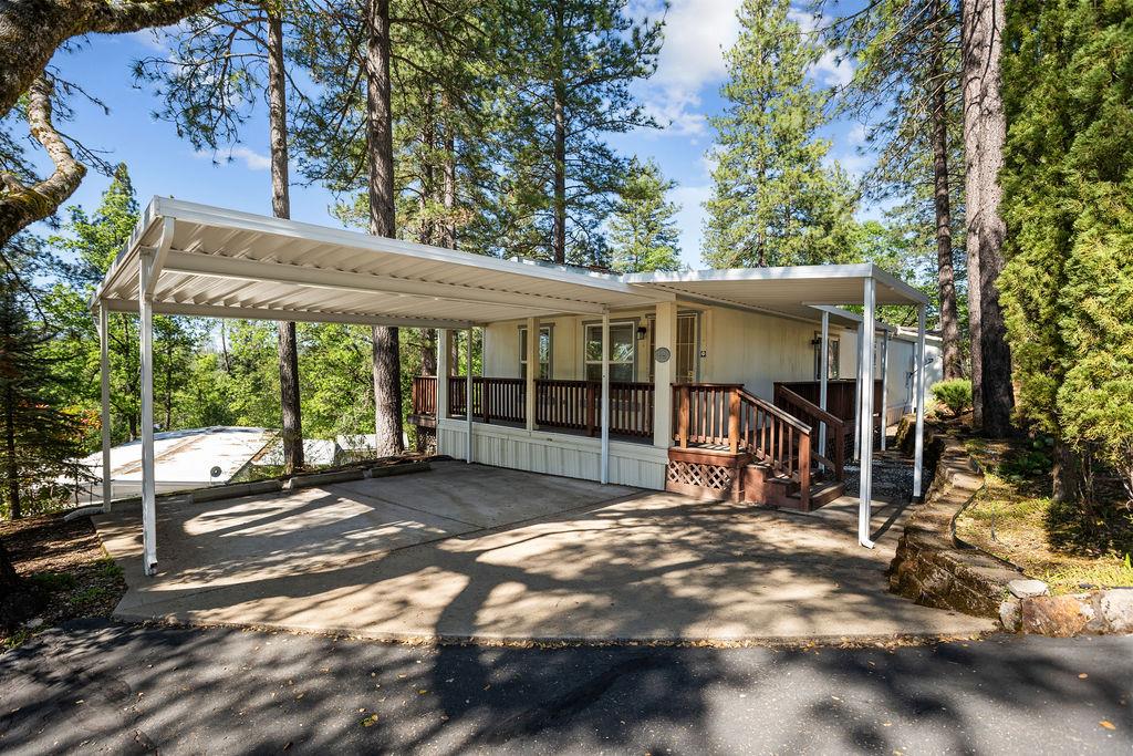 a view of a house with a large window and a yard