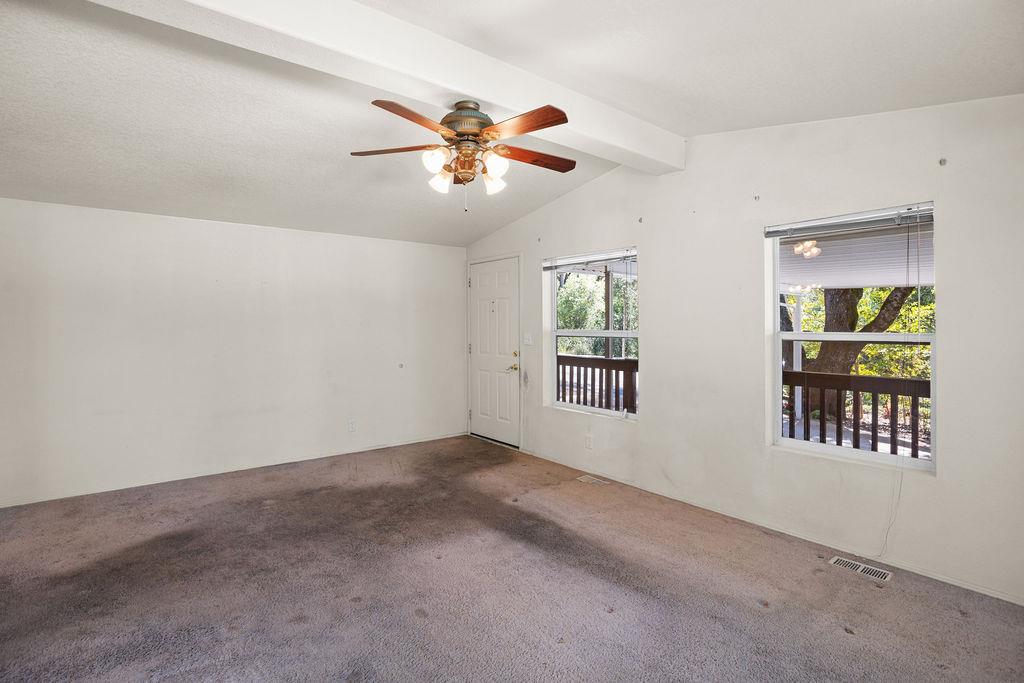 1281 Pleasant Valley Road, Unit 44 Diamond Springs, CA 95619 - Photo 11 of 29 an empty room with windows and fan