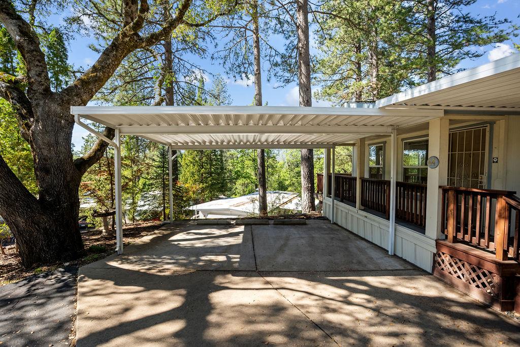 1281 Pleasant Valley Road, Unit 44 Diamond Springs, CA 95619 - Photo 3 of 29 a view of a patio with a table and chairs and floor to ceiling window