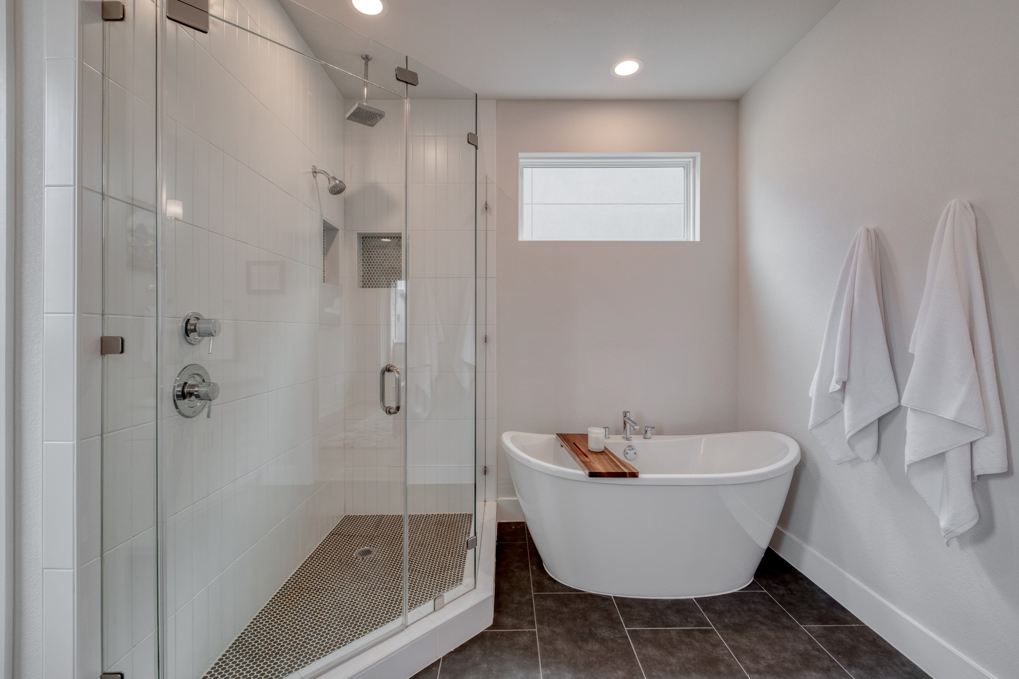 5002 Pecan Springs Road, Unit 7 Austin, TX 78723 - Photo 23 of 34 A large step-in shower includes a rainfall shower head and floor-to-ceiling tile work
