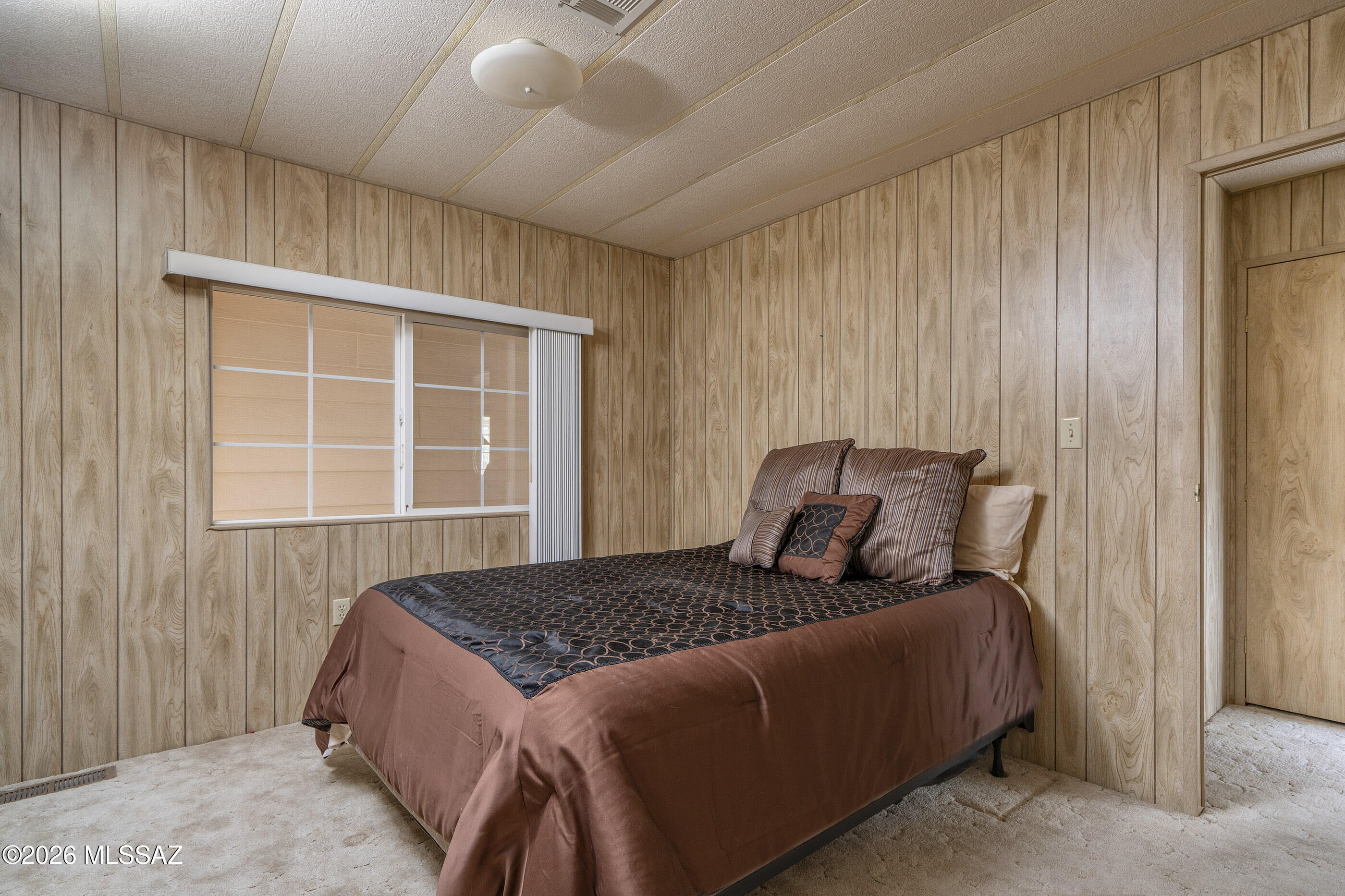 6121 West Flying M Street Tucson, AZ 85713 - Photo 14 of 25 a bedroom with a bed and window