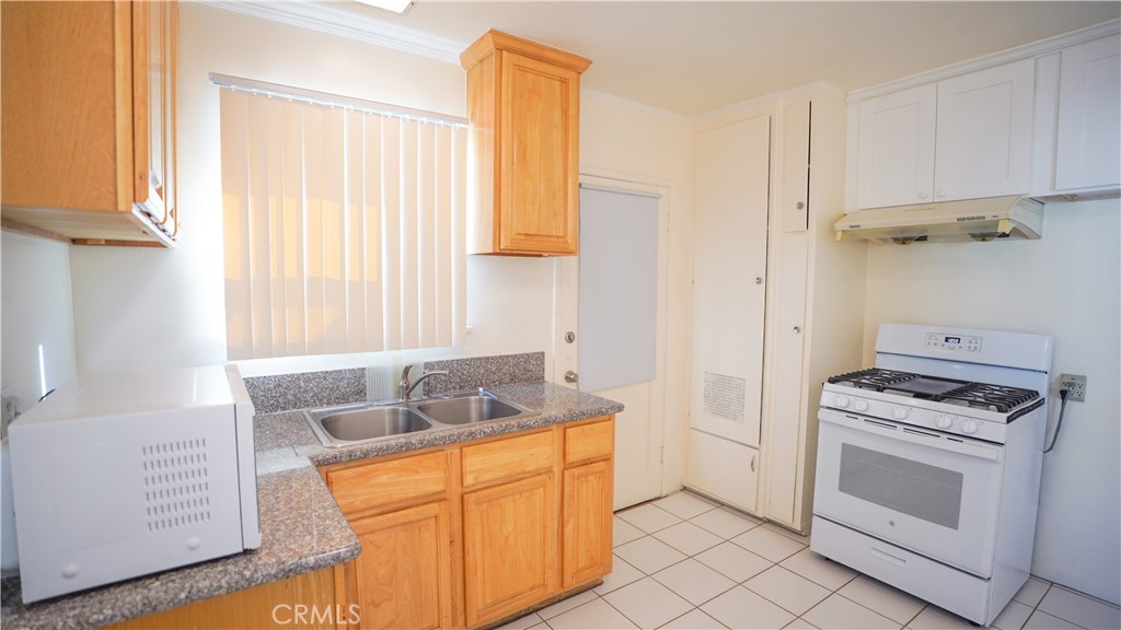 120 Lukens Place Glendale, CA 91206 - Photo 5 of 10 a kitchen with stainless steel appliances granite countertop a sink stove and cabinets