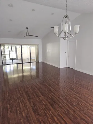 a view of a room with wooden floor and large windows