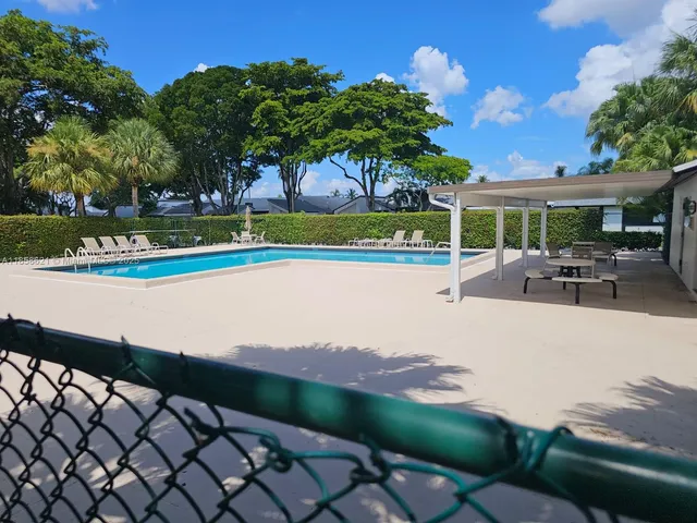 a view of a swimming pool with a patio