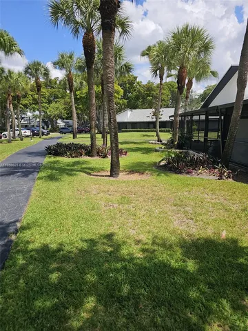 a view of a park with large trees