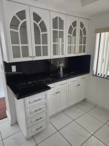 a kitchen with granite countertop a stove and a sink