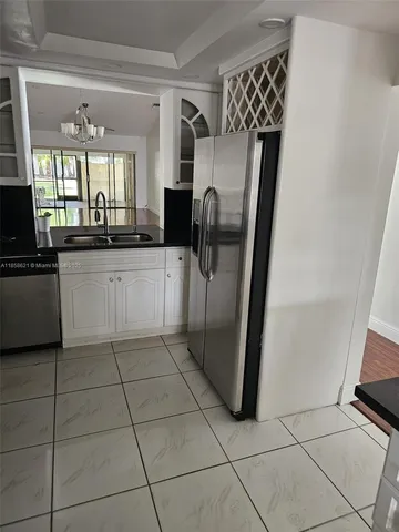 a kitchen with stainless steel appliances a refrigerator and a counter top space