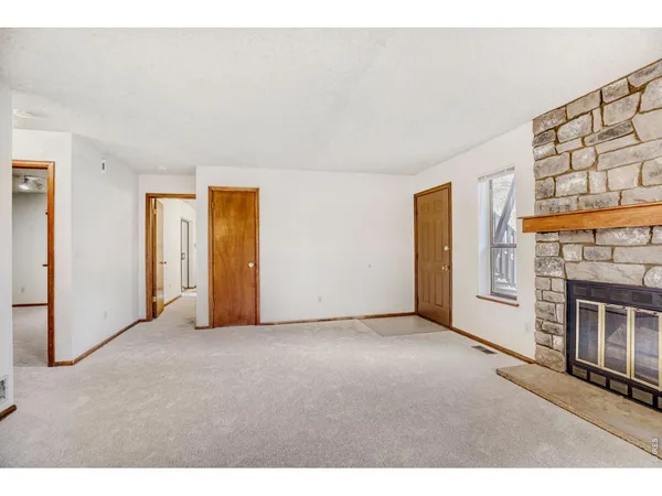 a view of empty room with a fireplace
