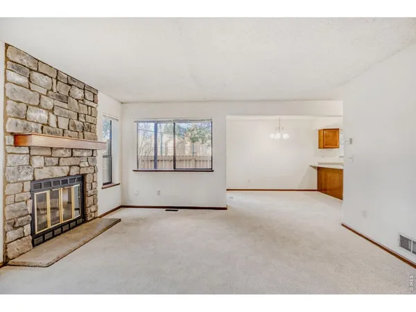 a view of an empty room with a fireplace