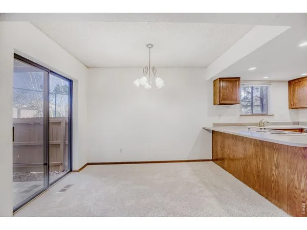 a kitchen with granite countertop a refrigerator and a sink