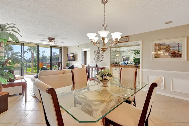 a view of a dining room with furniture wooden floor and chandelier