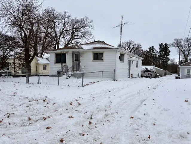 a white house that has a tree in front of it