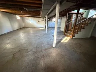 a view of an empty room with stairs