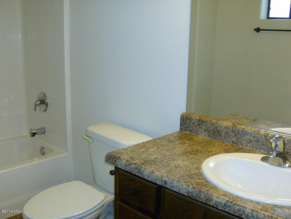 365 Via Papagayo Rio Rico, AZ 85648 - Photo 4 of 8 a bathroom with a granite countertop sink and a mirror