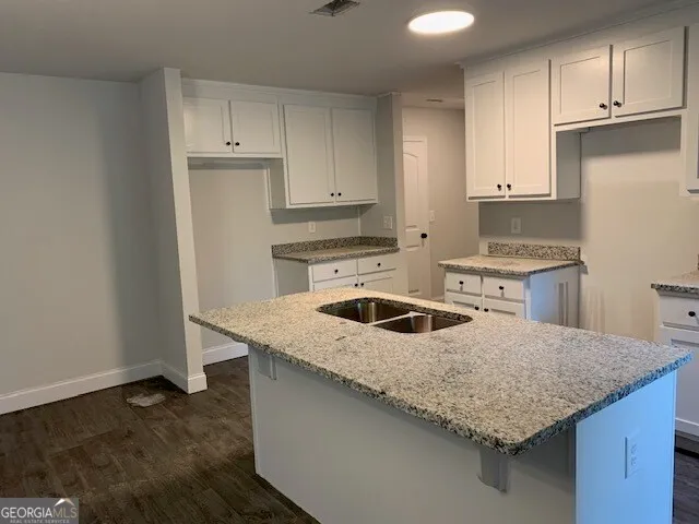 a view of a livingroom with wooden floor a fireplace and window