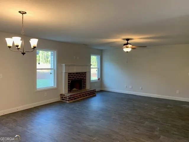 a view of a hallway with wooden floor and closet
