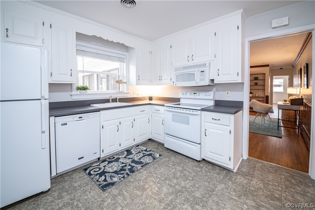 10201 Glendye Road Richmond, VA 23235 - Photo 16 of 50 a kitchen with white cabinets and white appliances