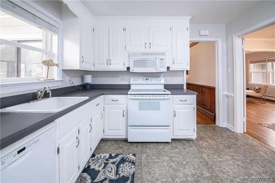 10201 Glendye Road Richmond, VA 23235 - Photo 17 of 50 a kitchen with white cabinets and white appliances