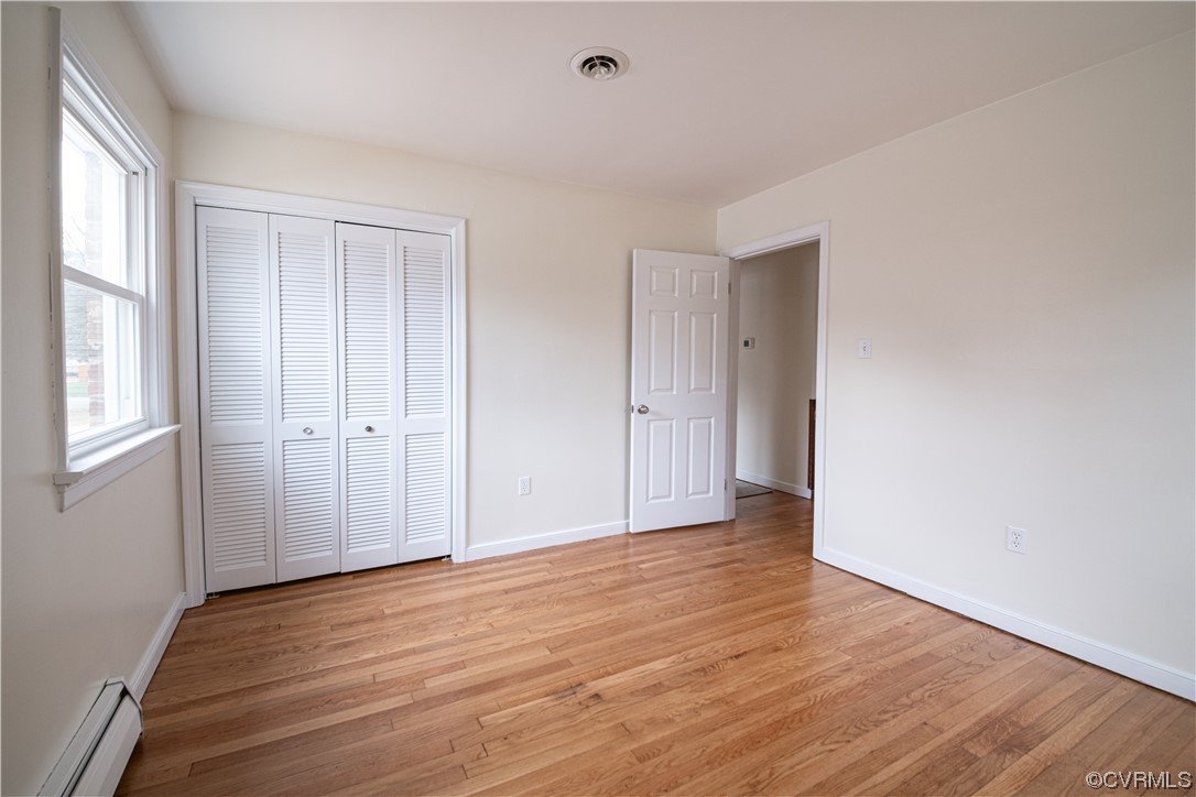 10201 Glendye Road Richmond, VA 23235 - Photo 40 of 50 a view of an empty room with wooden floor and a window