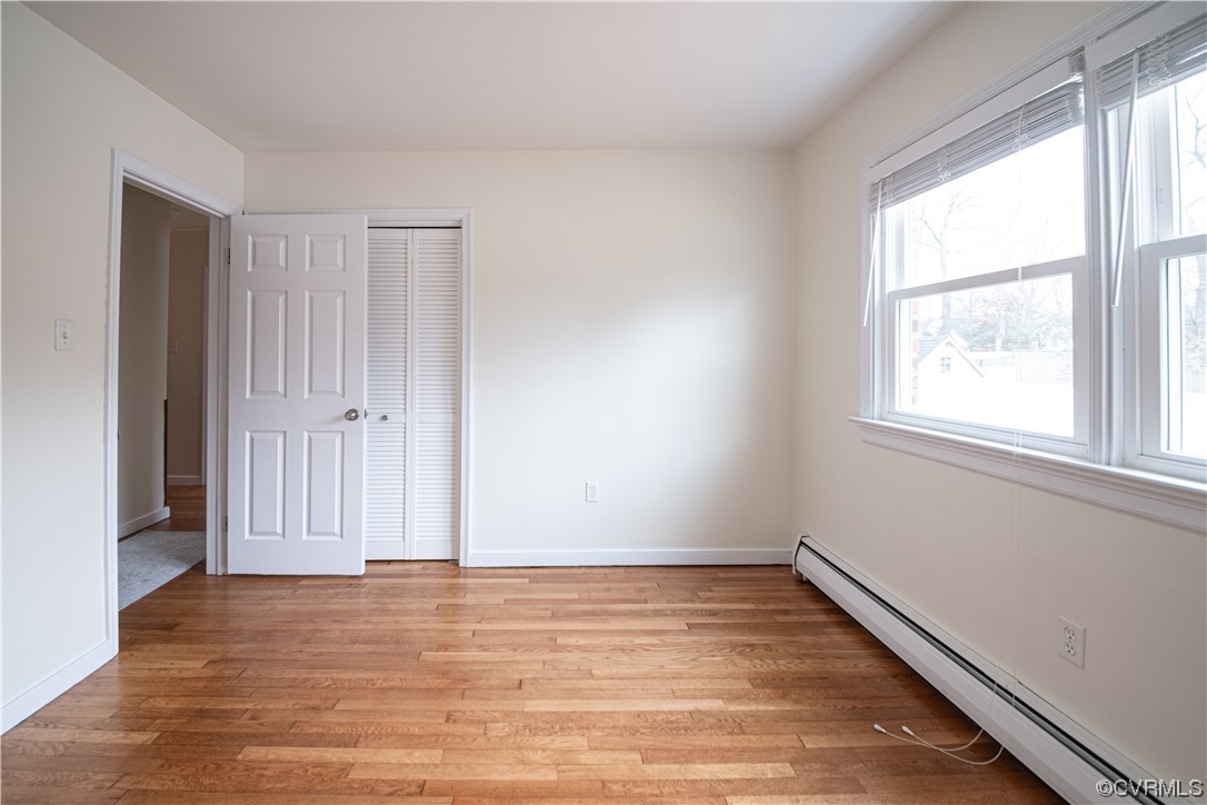 10201 Glendye Road Richmond, VA 23235 - Photo 41 of 50 an empty room with wooden floor and windows