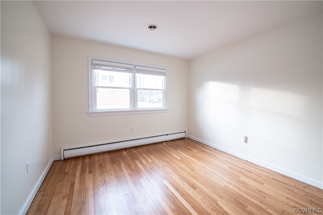10201 Glendye Road Richmond, VA 23235 - Photo 42 of 50 an empty room with wooden floor and windows