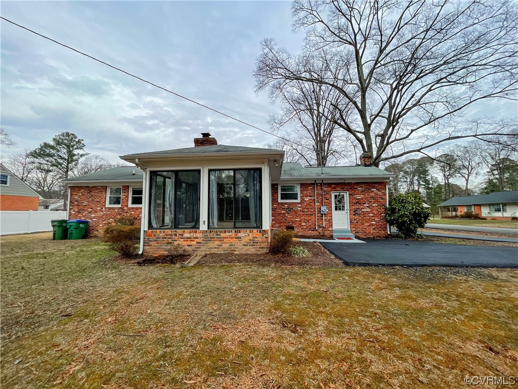 10201 Glendye Road Richmond, VA 23235 - Photo 48 of 50 a front view of a house with a garden and porch