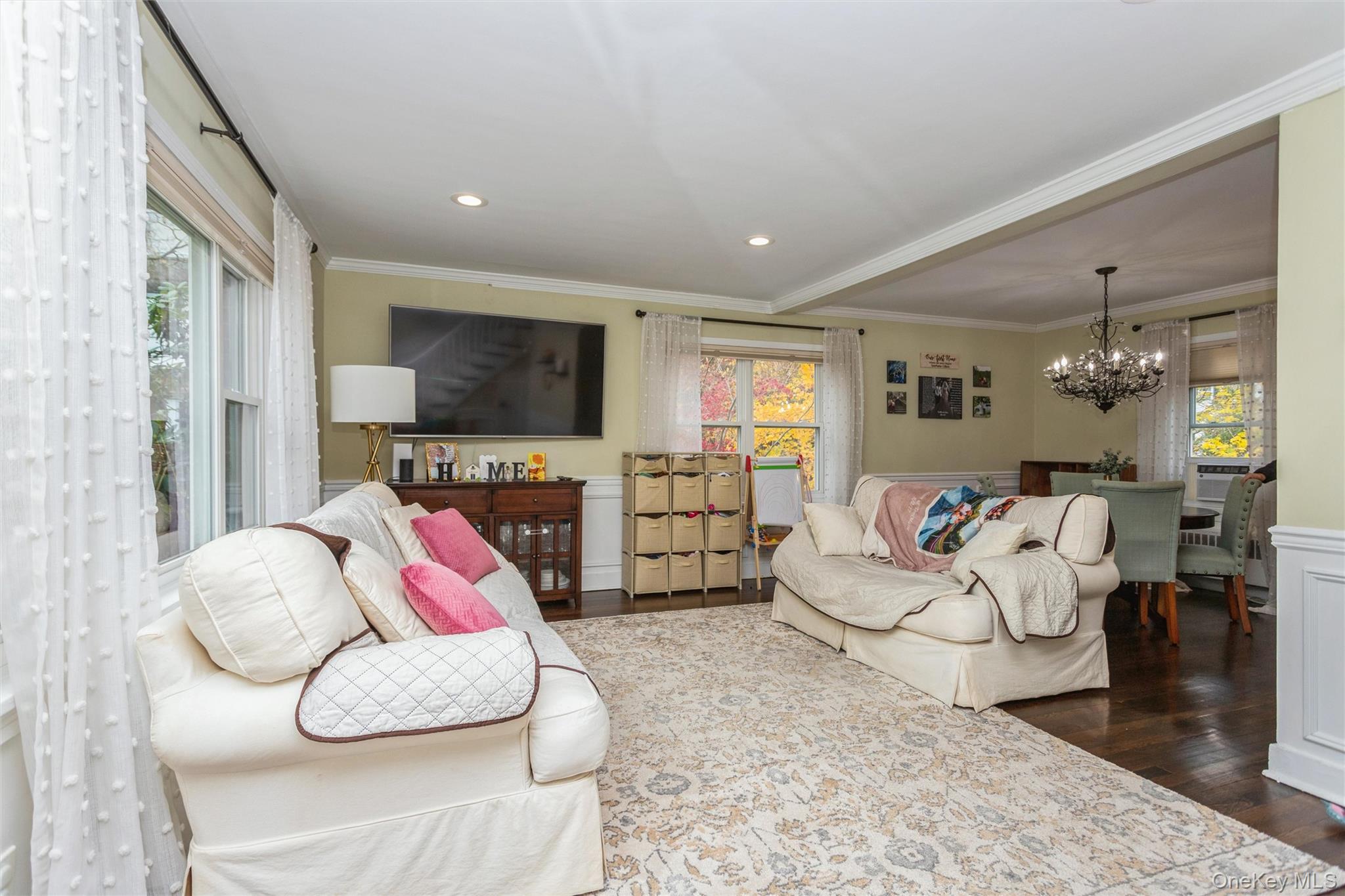 35 Peck Avenue, Unit 35A Rye, NY 10580 - Photo 11 of 27 Living room featuring ornamental molding, a wainscoted wall, wood finished floors, a chandelier, and recessed lighting