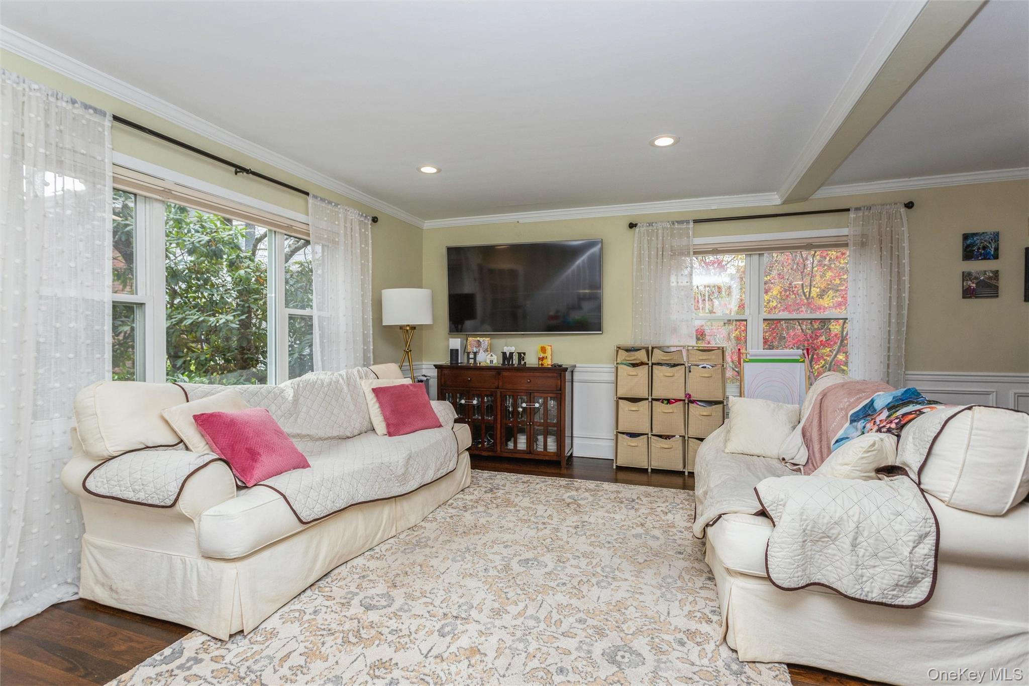35 Peck Avenue, Unit 35A Rye, NY 10580 - Photo 13 of 27 Living area featuring ornamental molding, a wainscoted wall, wood finished floors, beamed ceiling, and recessed lighting