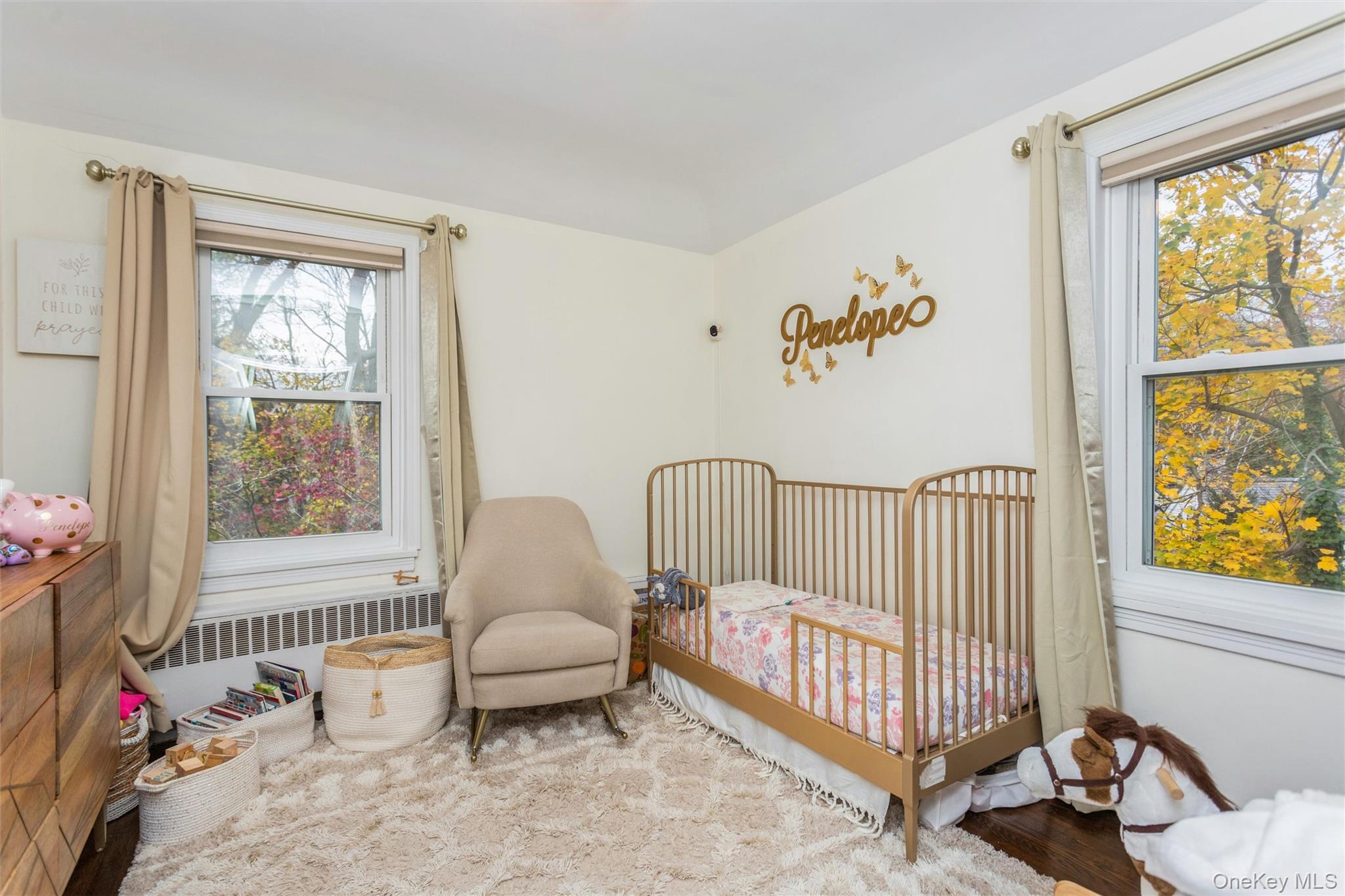 35 Peck Avenue, Unit 35A Rye, NY 10580 - Photo 18 of 27 Bedroom with radiator, a nursery area, and wood finished floors