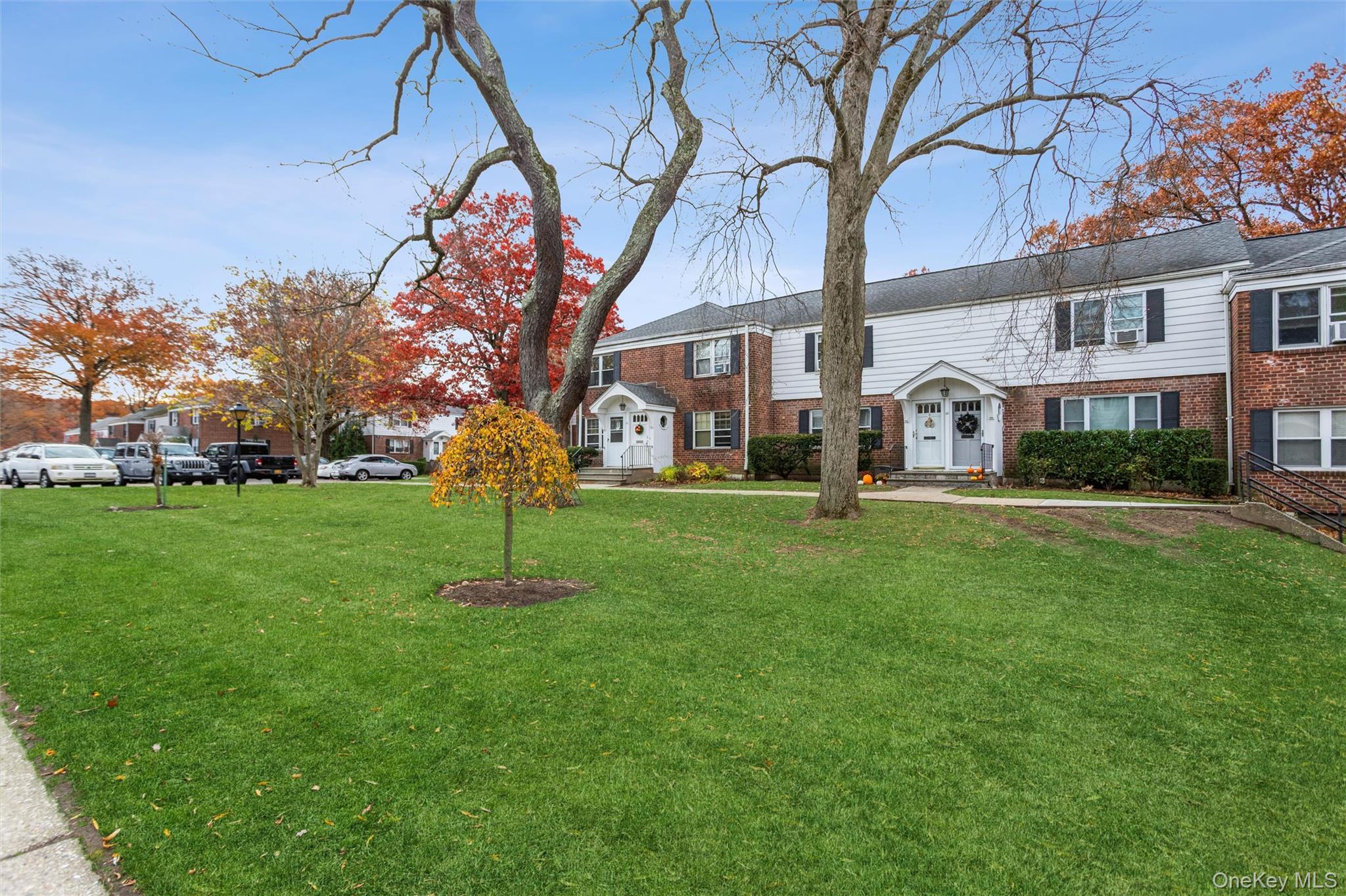 35 Peck Avenue, Unit 35A Rye, NY 10580 - Photo 20 of 27 View of front of property featuring brick siding and a front lawn