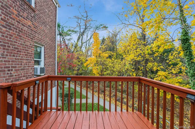 a view of a balcony with wooden floor