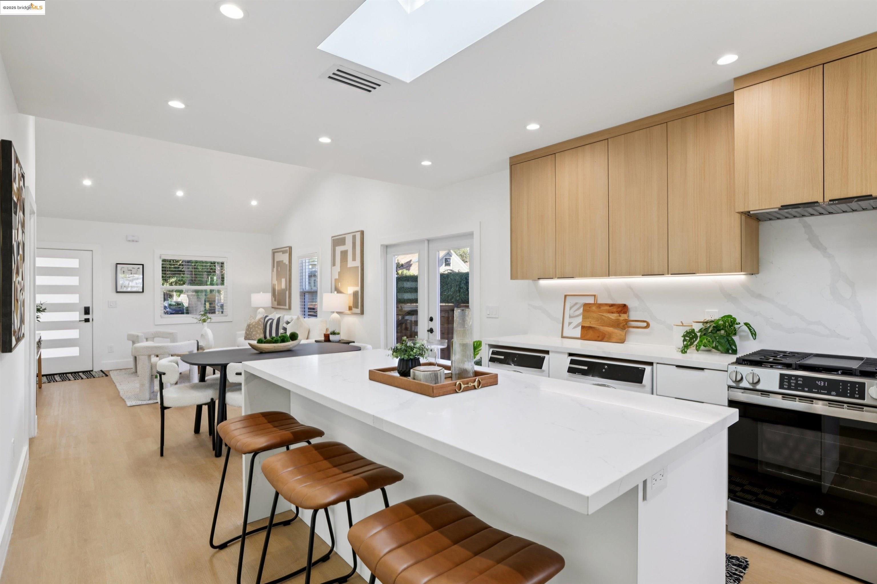 1612 Carleton Street Berkeley, CA 94703 - Photo 16 of 35 a kitchen with a dining table chairs stove and white cabinets