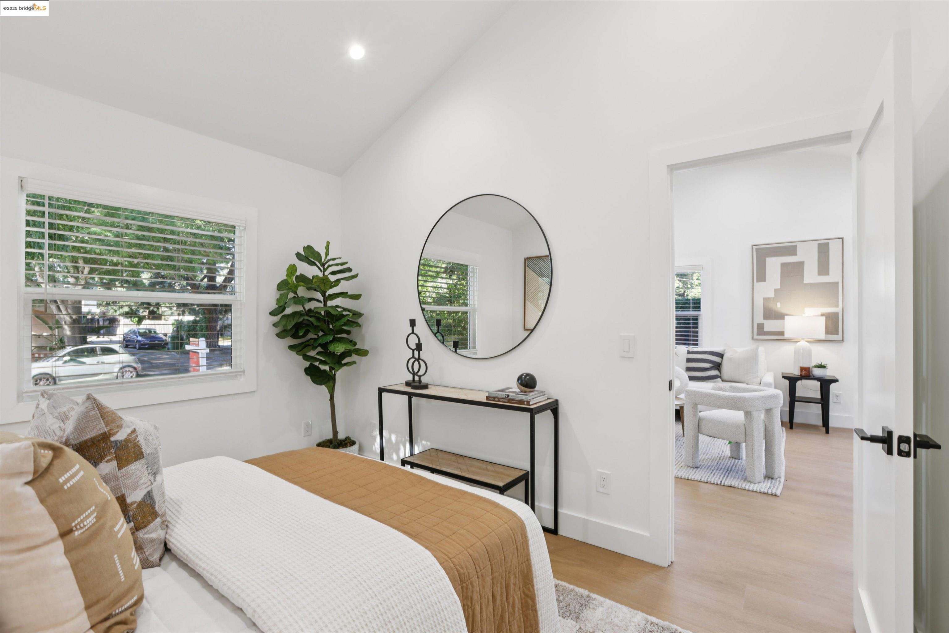 1612 Carleton Street Berkeley, CA 94703 - Photo 25 of 35 a bedroom with a bed a potted plant and a large window with outer view