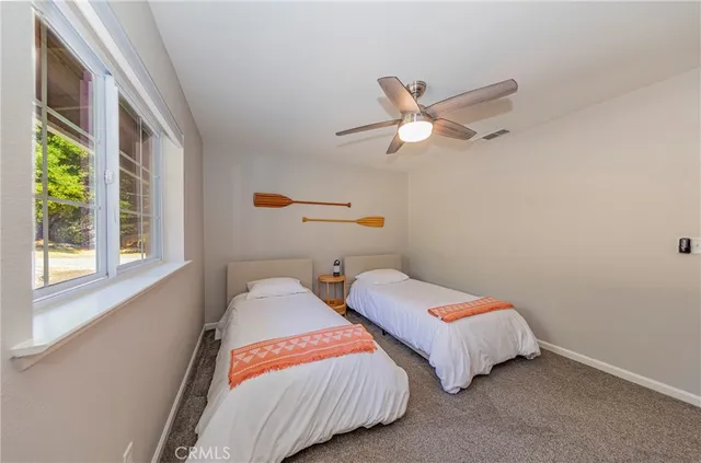 a view of a balcony with chairs and umbrella