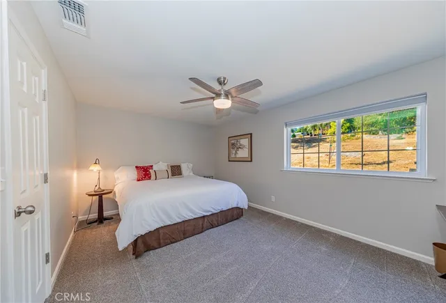 a front view of a house with a yard outdoor seating and mountain view