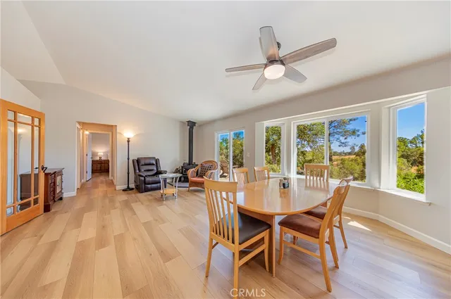 a kitchen with a sink a stove a refrigerator cabinets and wooden floor