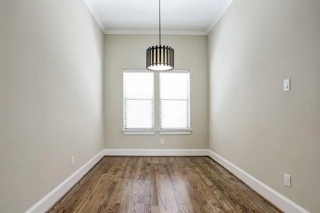 a view of a room with wooden floor window and a ceiling fan