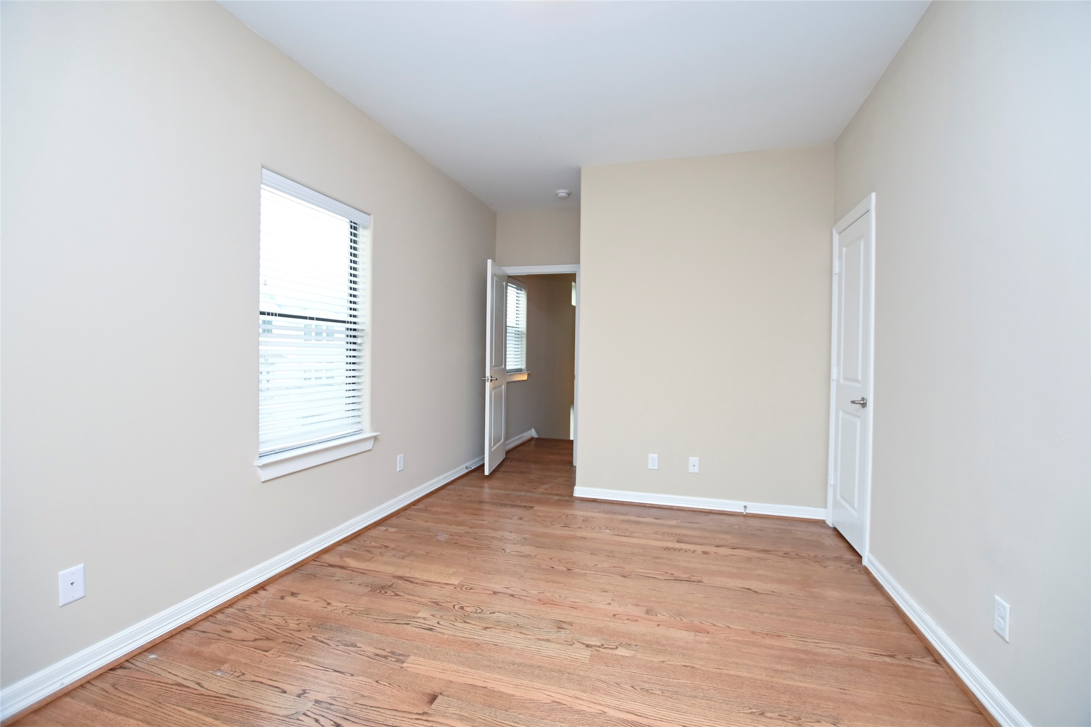 1601 West 24th Street, Unit A Houston, TX 77008 - Photo 26 of 28 an empty room with wooden floor and windows