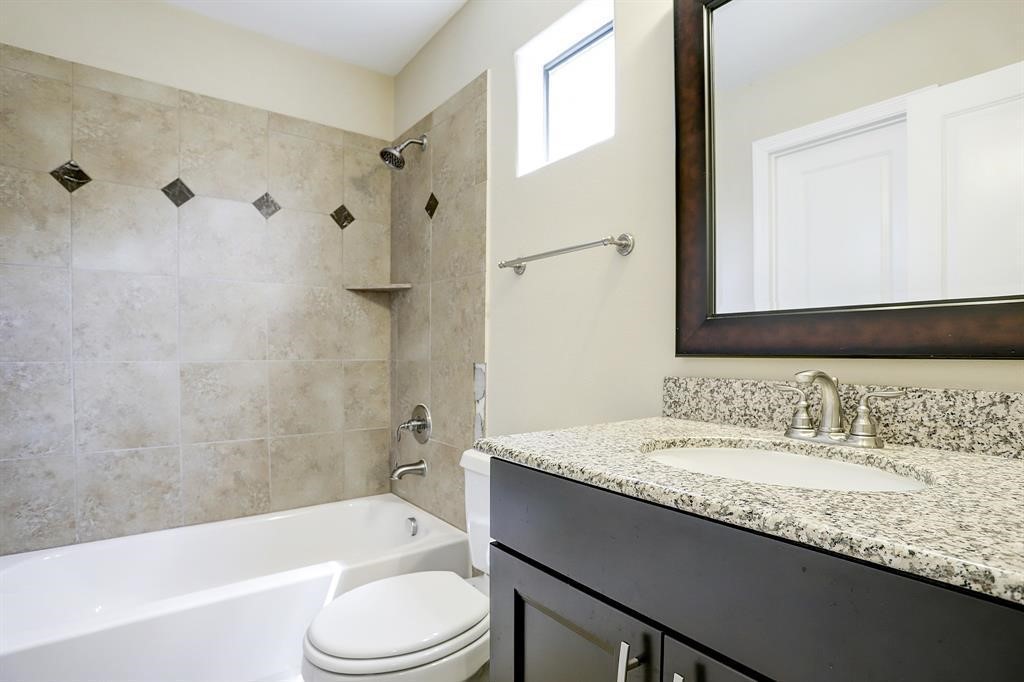 1601 West 24th Street, Unit A Houston, TX 77008 - Photo 27 of 28 a bathroom with a granite countertop sink toilet and shower