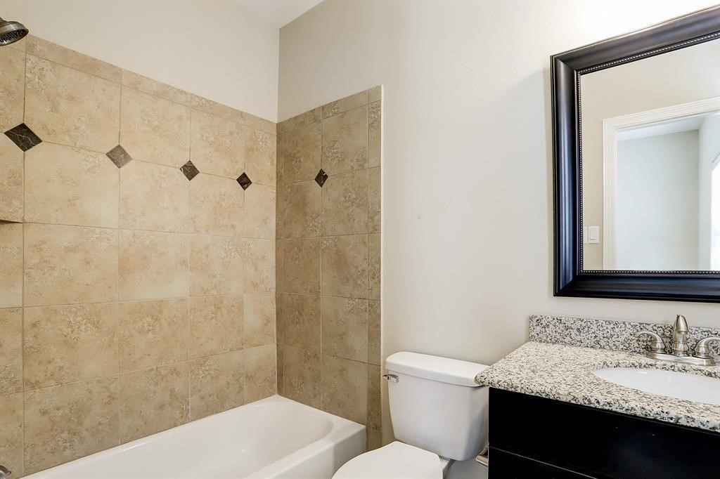 1601 West 24th Street, Unit A Houston, TX 77008 - Photo 6 of 28 a bathroom with a granite countertop sink toilet and shower