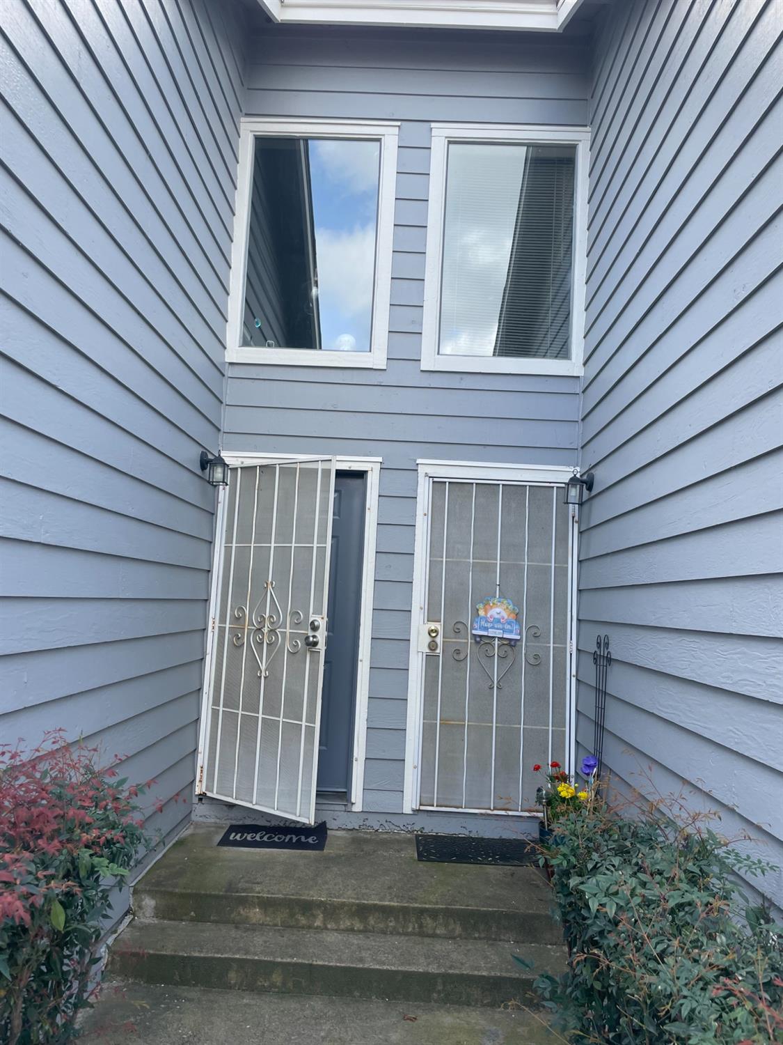 Front door on the right side with security screen.  Both units are for sale.