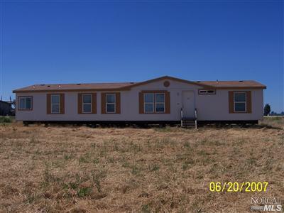 a view of a house with a wooden fence