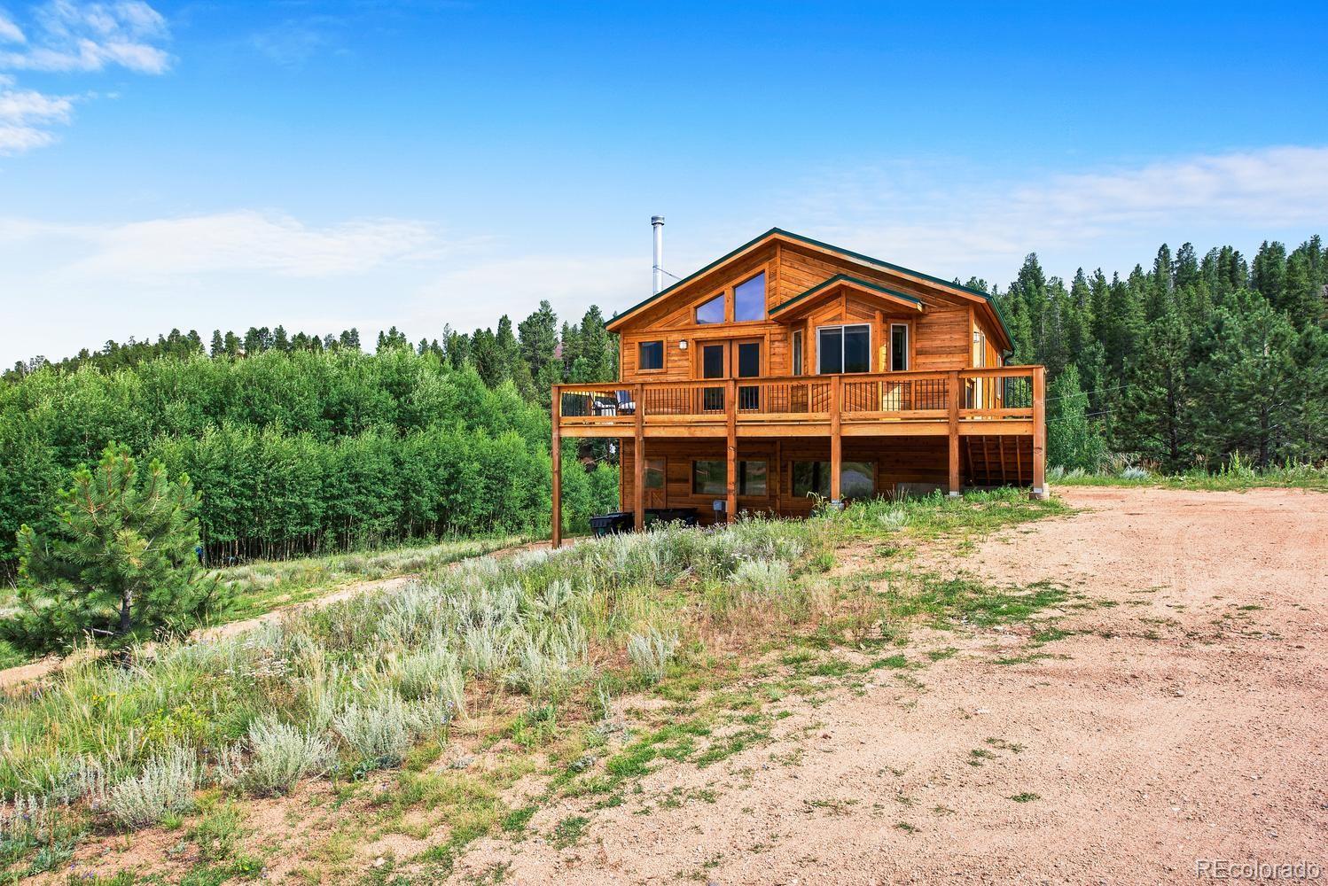 1328 Clark Road Bailey, CO 80421 - Photo 2 of 37 a front view of a house with a yard