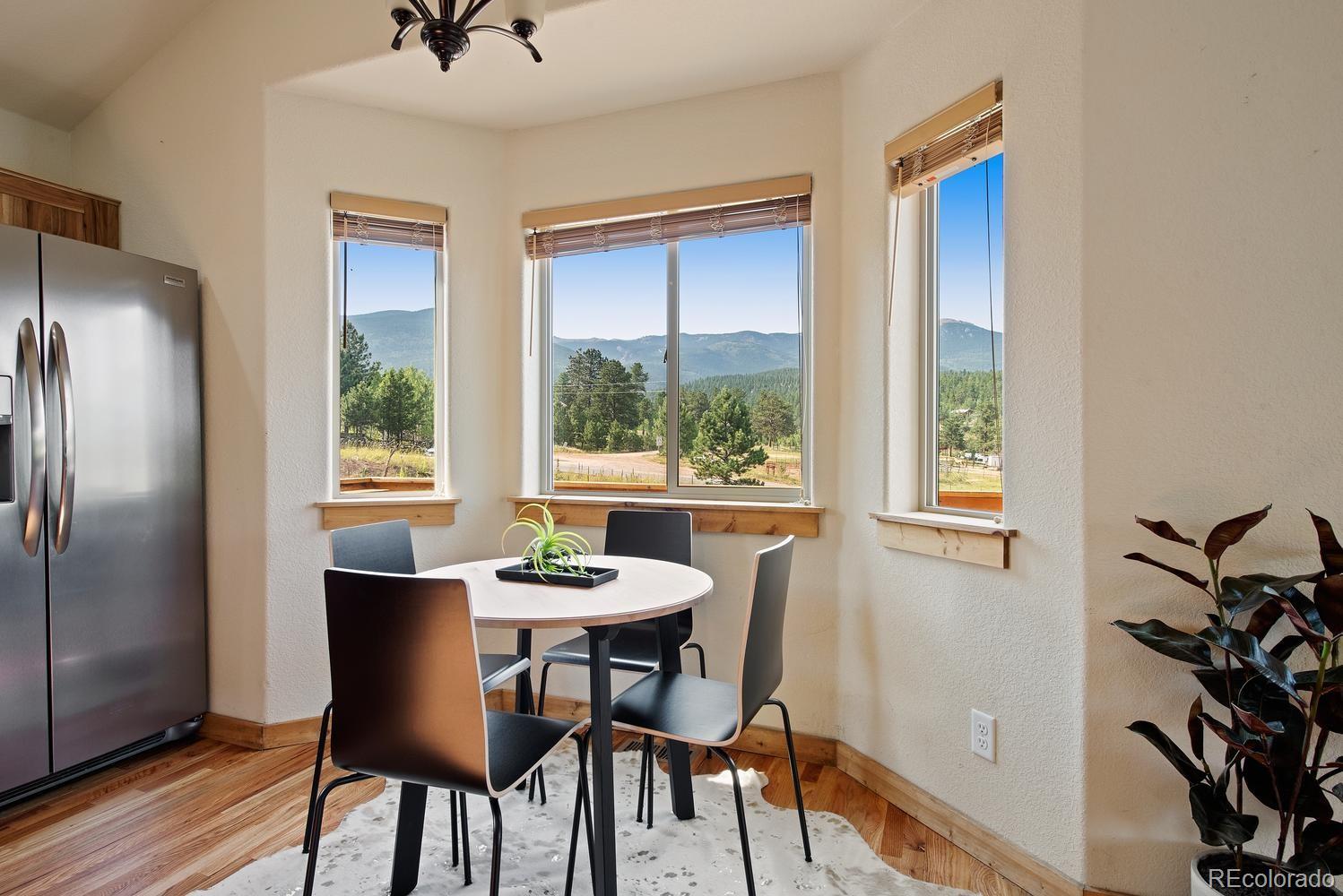 1328 Clark Road Bailey, CO 80421 - Photo 21 of 37 a dining room with furniture and window