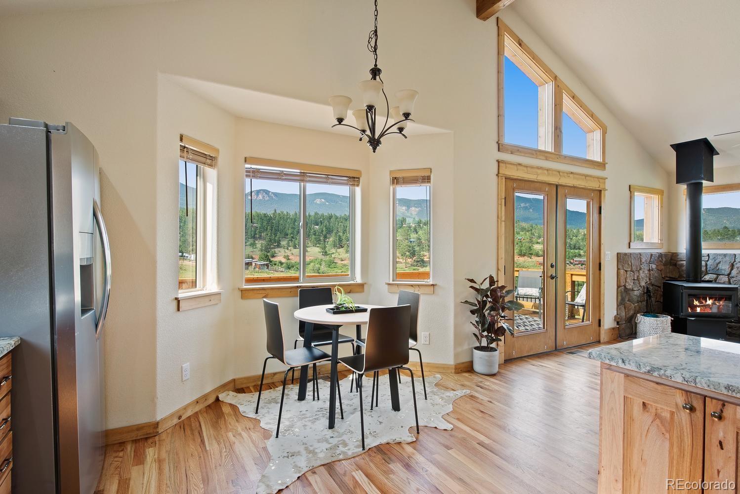 1328 Clark Road Bailey, CO 80421 - Photo 22 of 37 a view of a dining room with furniture window and wooden floor