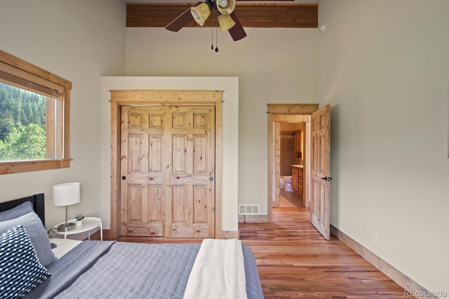 1328 Clark Road Bailey, CO 80421 - Photo 27 of 37 a view of a livingroom with wooden floor and a ceiling fan
